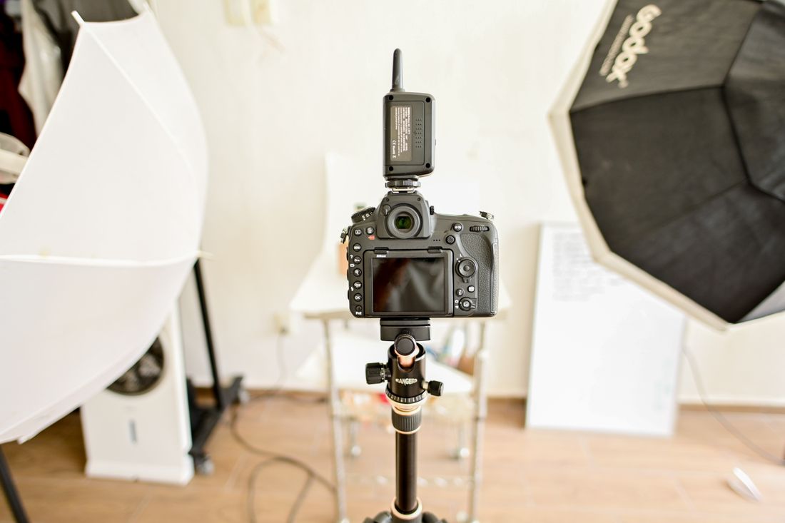 A digital camera and lighting equipment in an indoor studio.